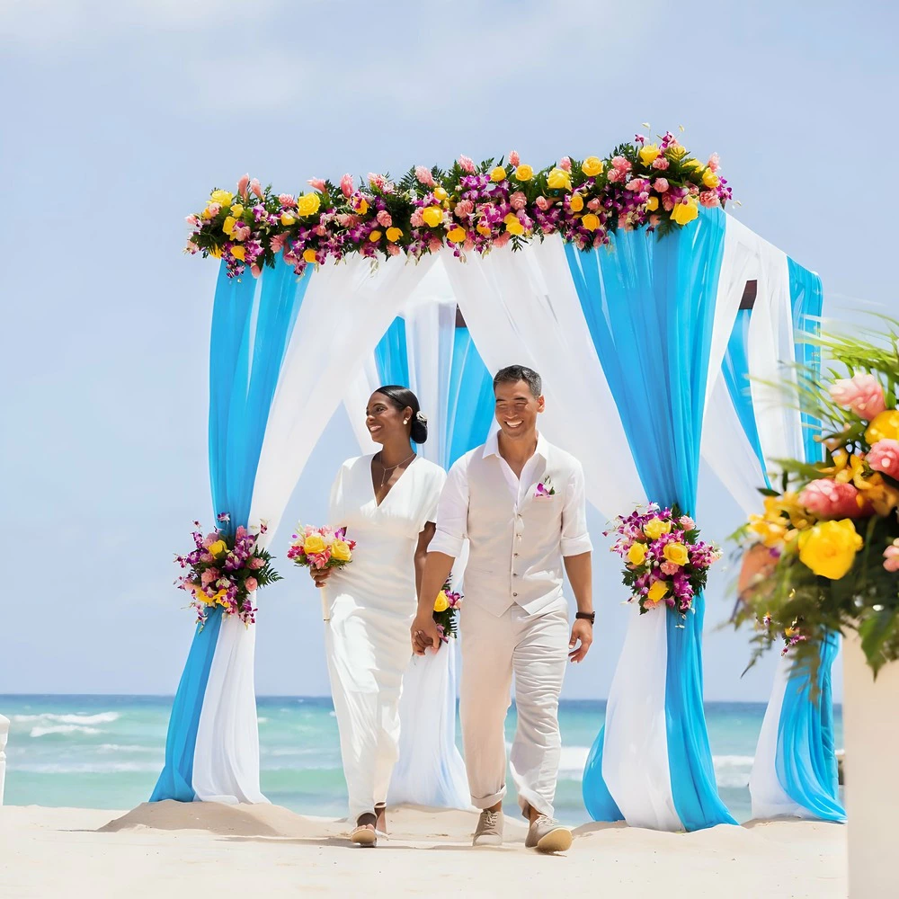 Newlywed couple walking beneath a floral wedding arch on the beach at Hyatt Zilara Rose Hall in Jamaica.