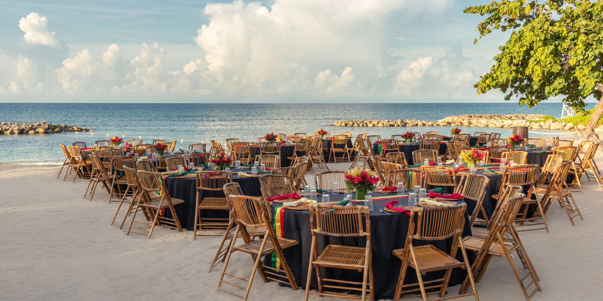 Elegant beachfront dining setup with tropical décor and ocean views at Hyatt Zilara Rose Hall in Montego Bay.