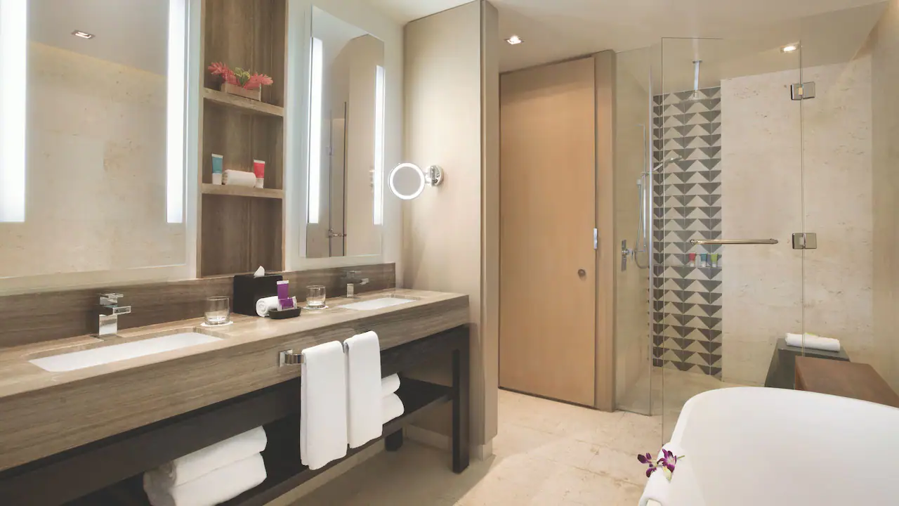 Junior Suite Double bathroom with soaking tub, rain shower, and dual vanity at Hyatt Zilara Rose Hall.