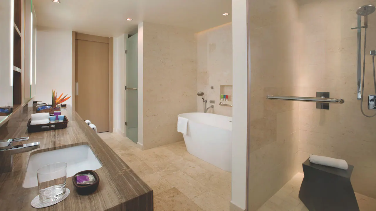 Oceanfront Grand Butler Suite bathroom with soaking tub and walk-in rain shower at Hyatt Zilara Rose Hall.