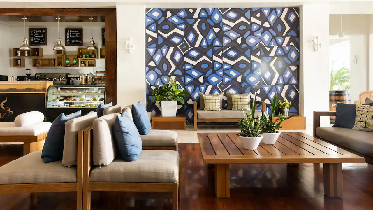 Stylish resort lobby with modern furnishings and café seating at Hyatt Zilara Rose Hall in Jamaica.