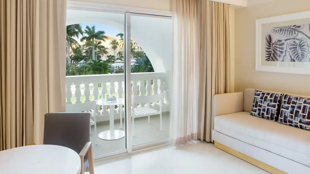 Resort View King sitting area with sleeper sofa and furnished terrace at Hyatt Zilara Rose Hall.